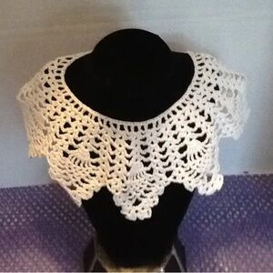 Elegant White hand crocheted collar for adding a touch of elegance to an outfit.